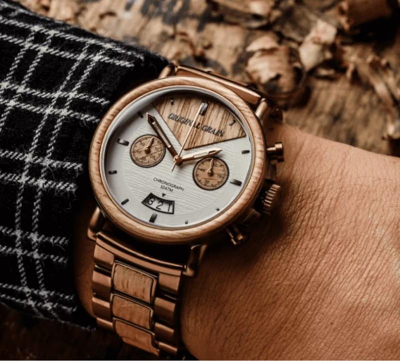Copper chronograph watch on plaid fabric displaying precise time for logistics and shipping