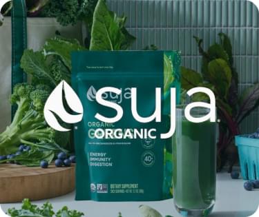Suja Organic green juice bottles with vegetables in the background, eCommerce fulfillment solutions