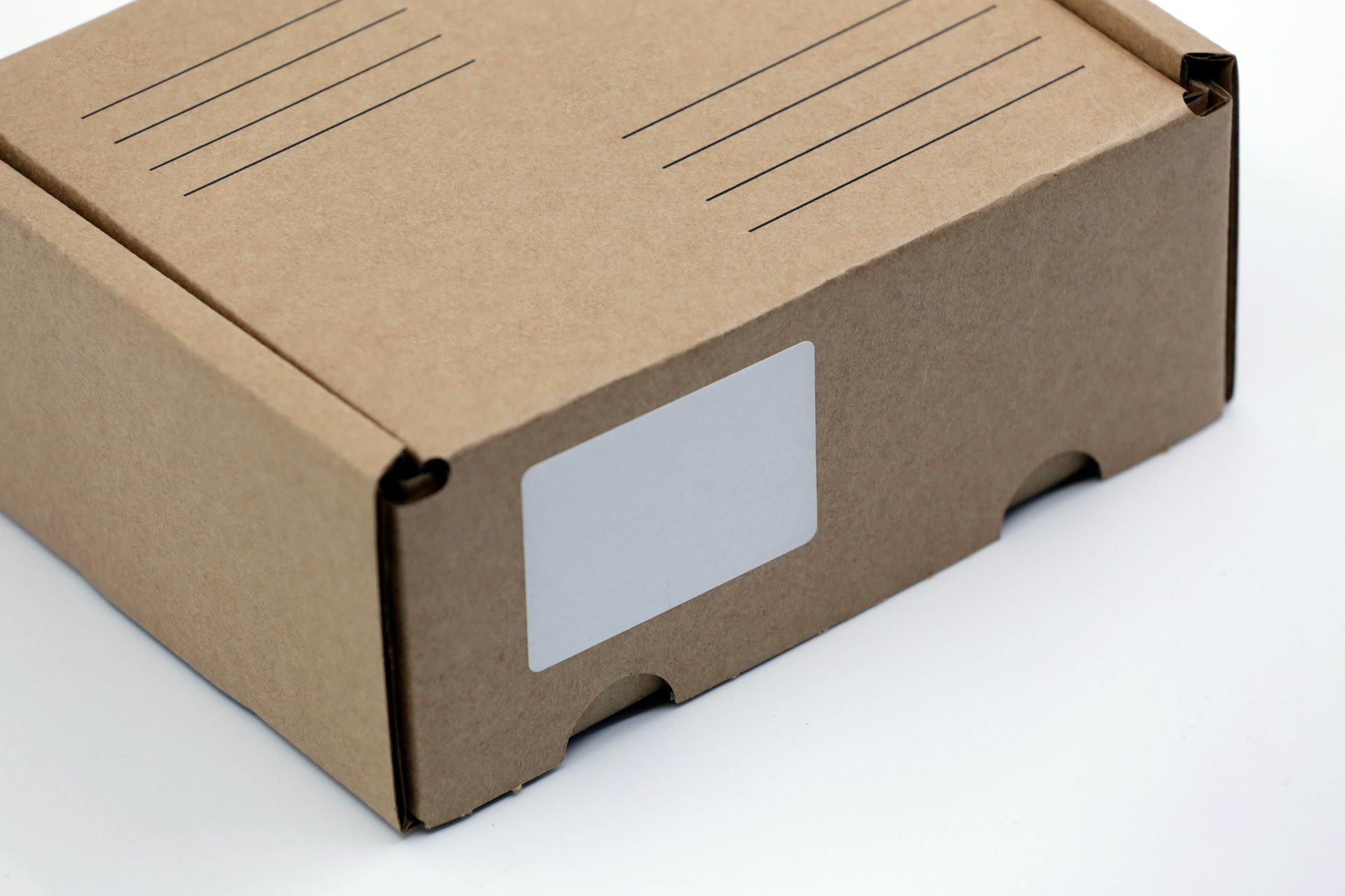 A brown box with a blank shipping label