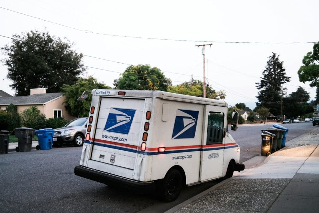 USPS delivery truck parked on residential street for last-mile eCommerce order fulfillment