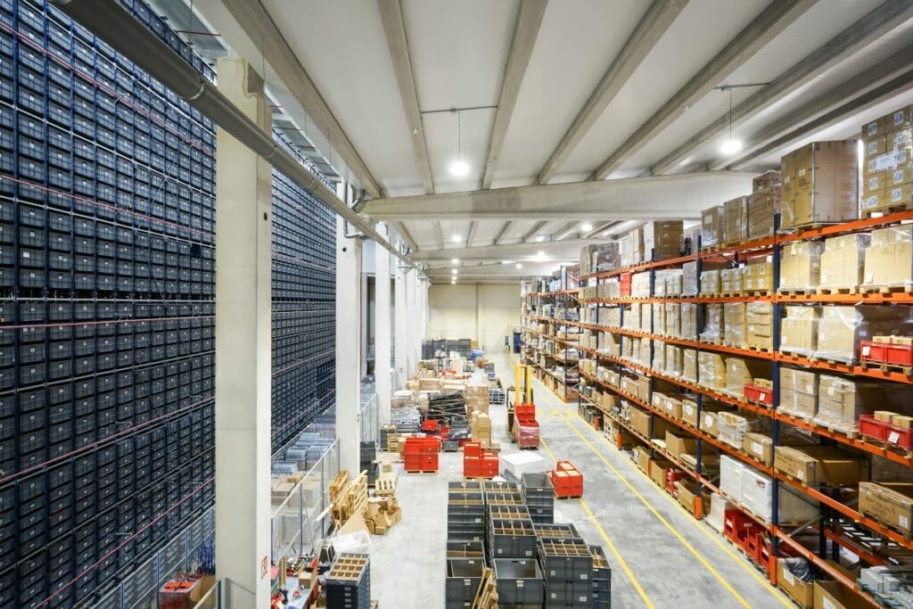 Warehouse storage facility with shelves of products and containers for eCommerce order fulfillment.