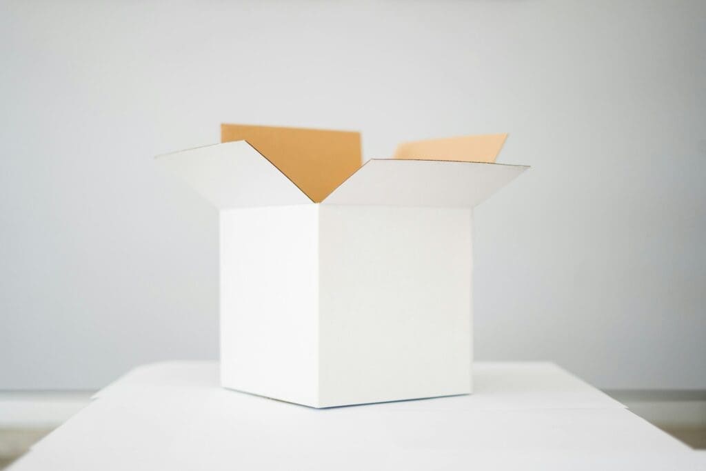 White open box with flaps on gray background, representing eCommerce packaging and fulfillment solutions