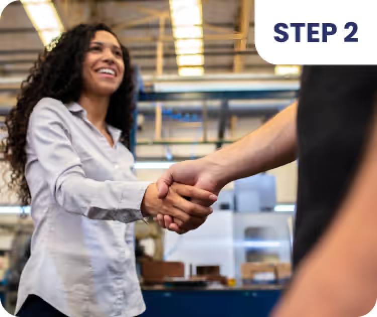 Woman shaking hands with man in warehouse, eCommerce order fulfillment step 2