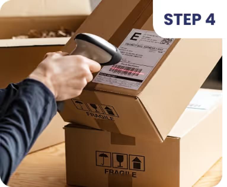 Person scanning shipping label on brown box marked "FRAGILE" with barcode scanner, following Step 4
