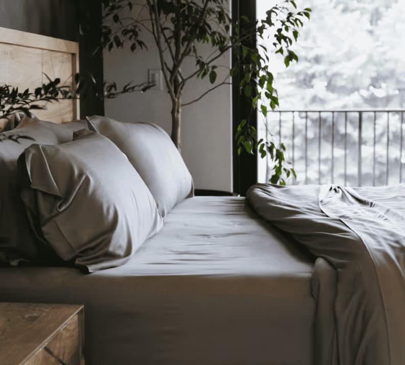 Luxury bedroom with neutral bedding and plants, overlooking scenic view for eCommerce fulfillment