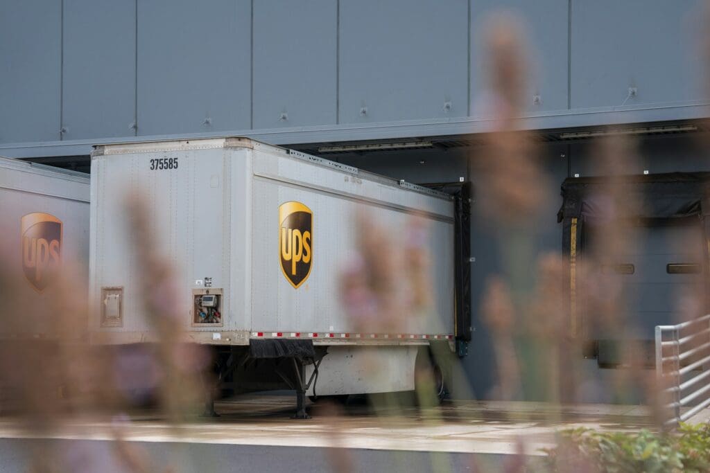 A UPS truck in front of a warehouse