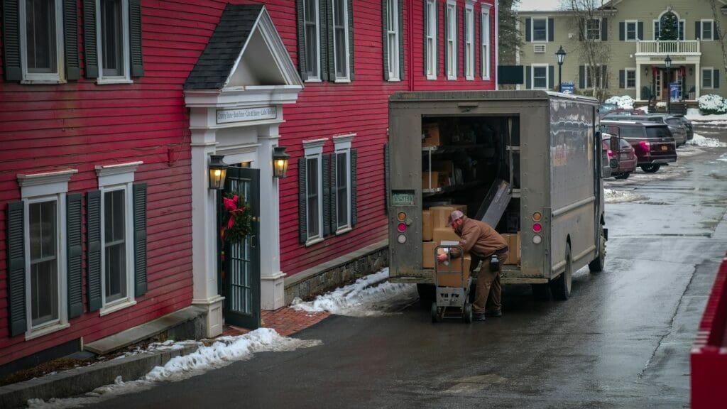 Packages being unloaded from an unbranded delivery truck