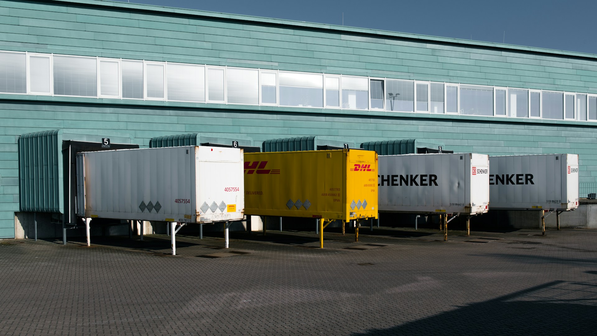 Shipping containers attached to a 3PL loading dock for pallet transfer