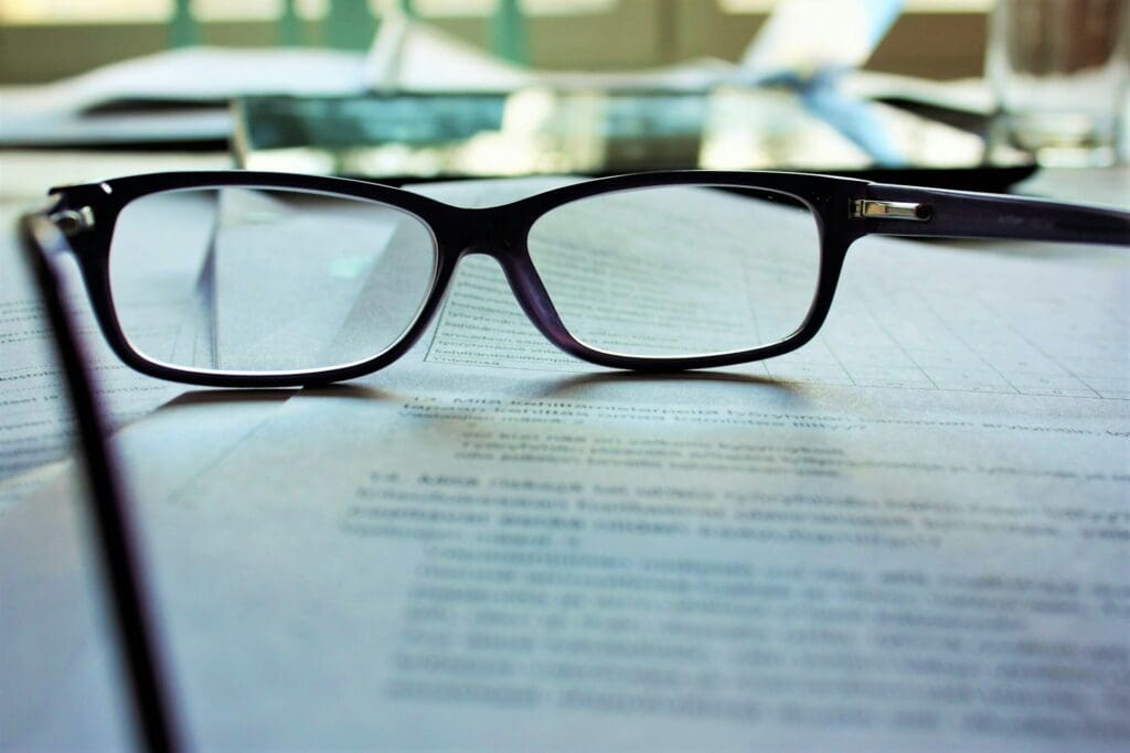 A pair of glasses resting on a contract
